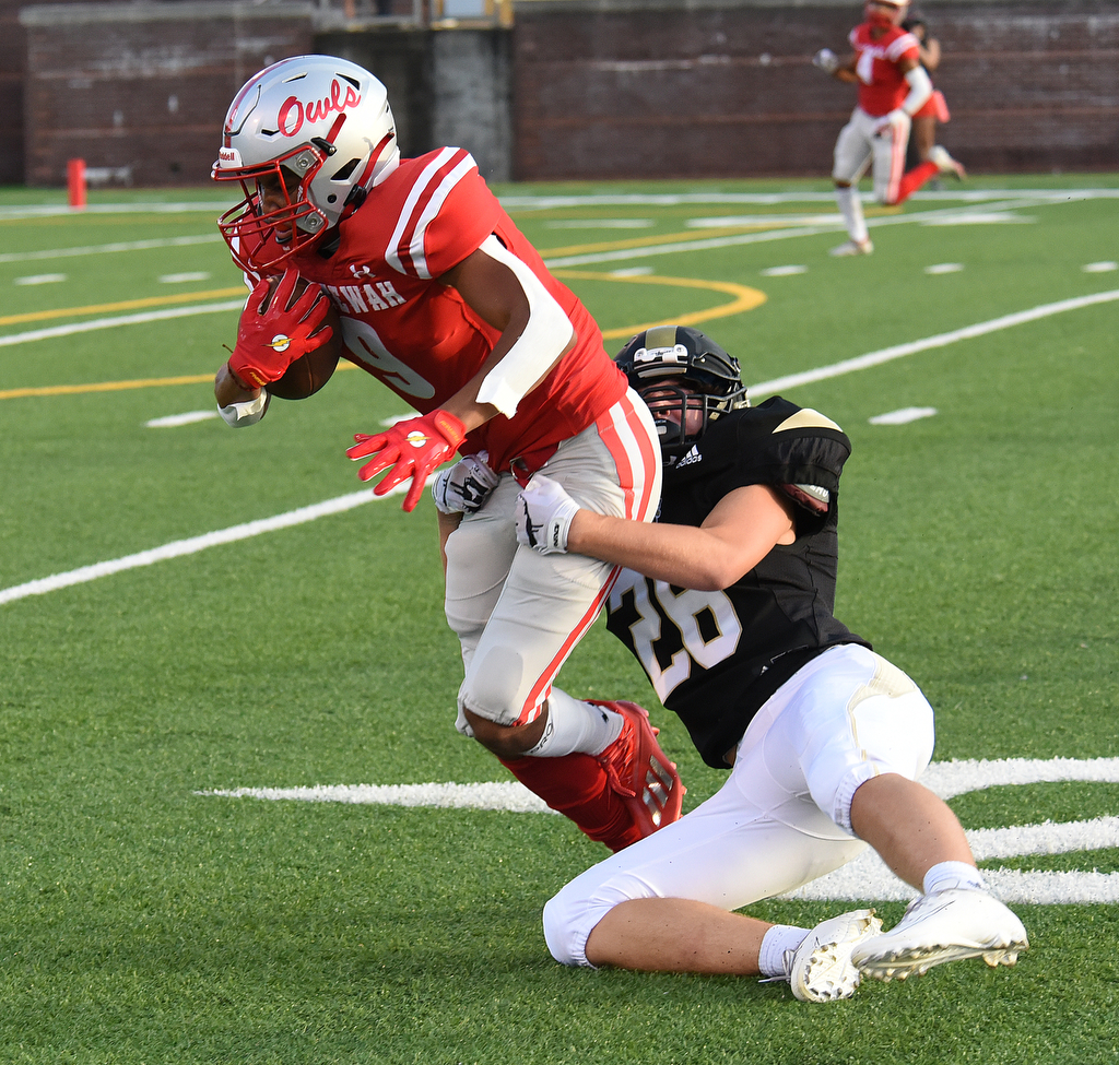 Staff Photo by Matt Hamilton / Ooltewah (9) Dawson Jones carries the ball as Lookout Valley (26) Bailey Teague tackles him Friday. Eight local football teams squared off in eight different 20-minute games Friday, August 13, 2021 at Finley Stadium.