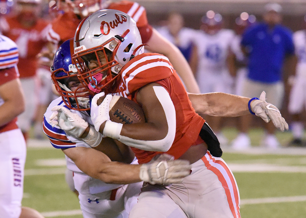 Staff Photo by Matt Hamilton / Ooltewah (2) Jordan Green carries the ball as Cleveland (12) Edward Couvillion makes the tackle Friday. Eight local football teams squared off in eight different 20-minute games Friday, August 13, 2021 at Finley Stadium.