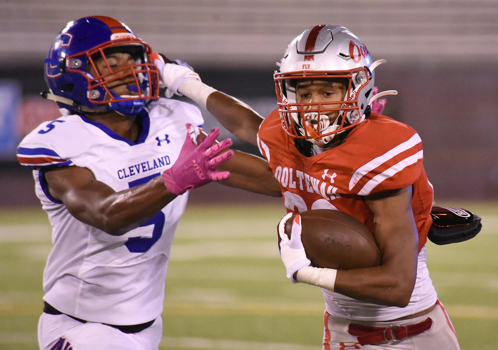Staff Photo by Matt Hamilton / Ooltewah (22) Takoda Jones carries the ball as Cleveland (5) Brian Beard Jr. defends Friday. Eight local football teams squared off in eight different 20-minute games Friday, August 13, 2021 at Finley Stadium.