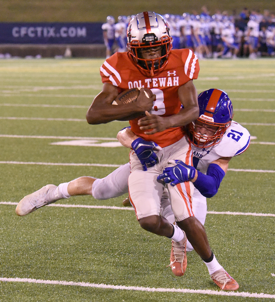 Staff Photo by Matt Hamilton / Ooltewah (8) Raymos McGee carries the ball as Cleveland (21) Tate O'Brian tackles him Friday. Eight local football teams squared off in eight different 20-minute games Friday, August 13, 2021 at Finley Stadium.