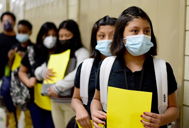 Staff Photo by Robin Rudd / Orchard Knob Middle School sixth grade students wear masks as they line up to go into Melanie Raybon's classroom. Orchard Knob Middle School started the 2021-2022 school on Aug. 12, 2021, amid a surge in the delta variant of the coronavirus.