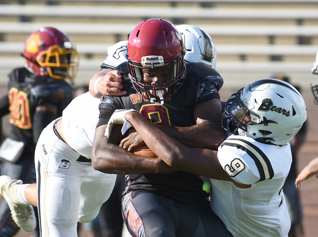 Staff Photo by Matt Hamilton / Bradley Central (1) Gage Anderson and (9) Isaiah Arnold tackle Howard (9) London Cross Saturday. Eight local football teams squared off in eight different 20-minute games Saturday August 14, 2021 at Finley Stadium.