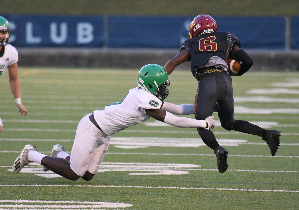 Staff Photo by Matt Hamilton / East Hamilton (9) Makail Pratt grabs Howard (6) Tragontae Lewis Saturday. Eight local football teams squared off in eight different 20-minute games Saturday August 14, 2021 at Finley Stadium.