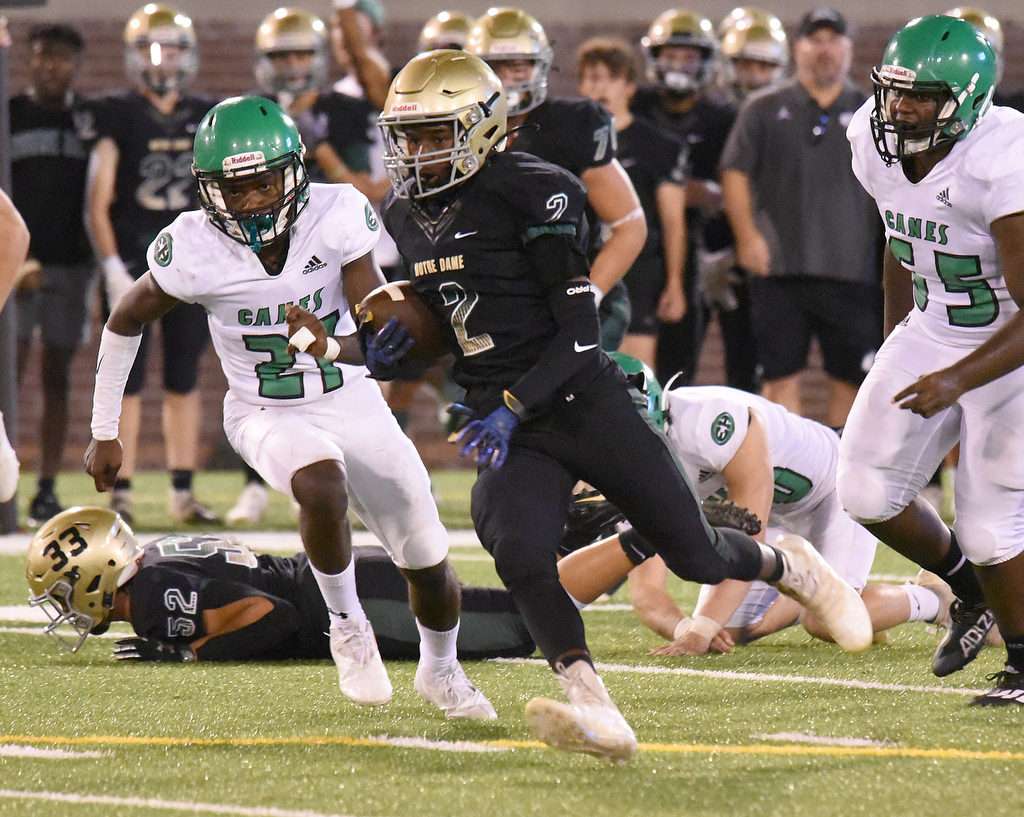 Staff Photo by Matt Hamilton / Notre Dame (2) Kenny Hammond runs with the ball after a catch against East Hamilton Saturday. Eight local football teams squared off in eight different 20-minute games Saturday August 14, 2021 at Finley Stadium.