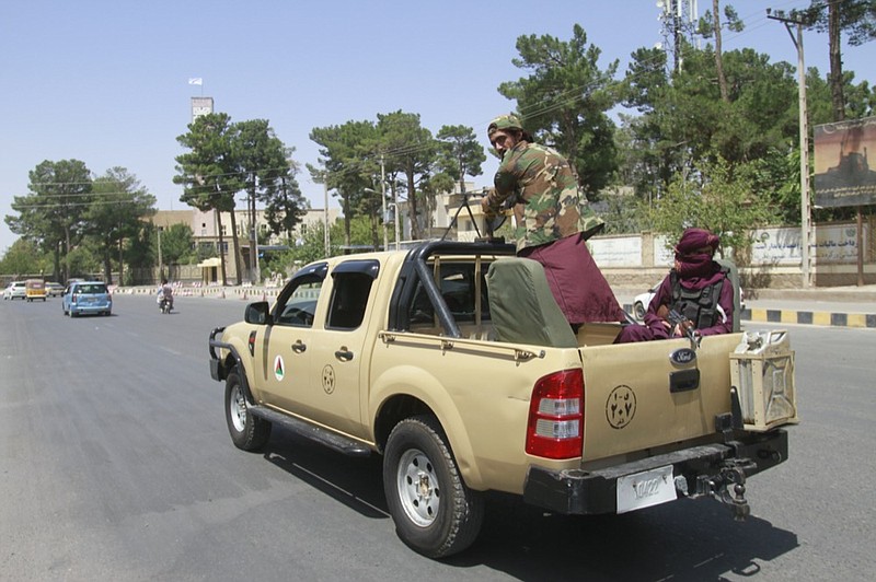 Taliban fighters sit on the back of a vehicle in the city of Herat, west of Kabul, Afghanistan, Saturday, Aug. 14, 2021, after they took this province from Afghan government. The Taliban seized two more provinces and approached the outskirts of Afghanistan's capital. (AP Photo/Hamed Sarfarazi)


