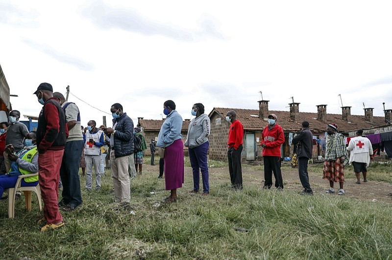 Kenyans queue to receive the AstraZeneca coronavirus vaccine donated by Britain, at the Makongeni Estate in Nairobi, Kenya Saturday, Aug. 14, 2021. (AP Photo/Brian Inganga)


