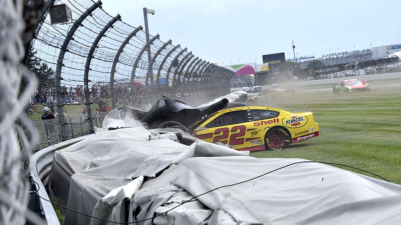 Joey Logano (22) crashes into a tire wall during a NASCAR Series auto race at Indianapolis Motor Speedway, Sunday, Aug. 15, 2021, in Indianapolis. (Randy Crist/The Indianapolis Star via AP)
