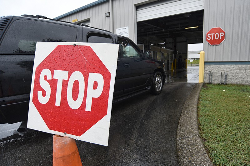Staff Photo by Matt Hamilton / A vehicle drives into the inspection area at the Vehicle Inspection Center at 720 Eastgate Loop in Chattanooga on Tuesday, August 17, 2021. 