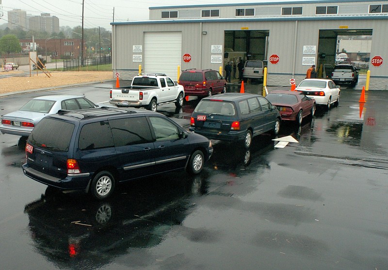 Staff File Photo / A line of cars waits outside the Riverfront Parkway auto emissions testing facility several years ago.