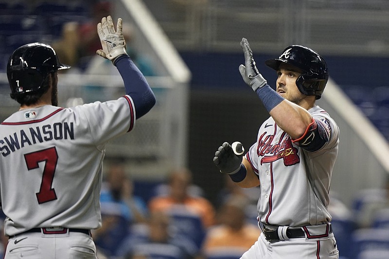 Atlanta Braves' Adam Duvall, right, celebrates with Dansby Swanson (7) after Duval hit a home run, scoring Swanson during the fourth inning of a baseball game against the Miami Marlins, Monday, Aug. 16, 2021, in Miami. (AP Photo/Wilfredo Lee)


