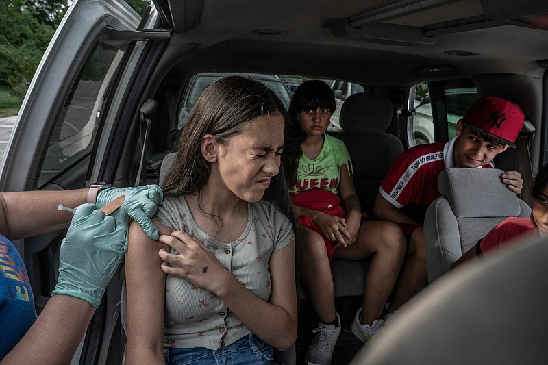 Esmeralda Baravar, 18, winces as she gets her COVID-19 vaccine during a pop-up clinic at Our Lady of Guadalupe Catholic Church in South Nashville. (Photo: John Partipilo)