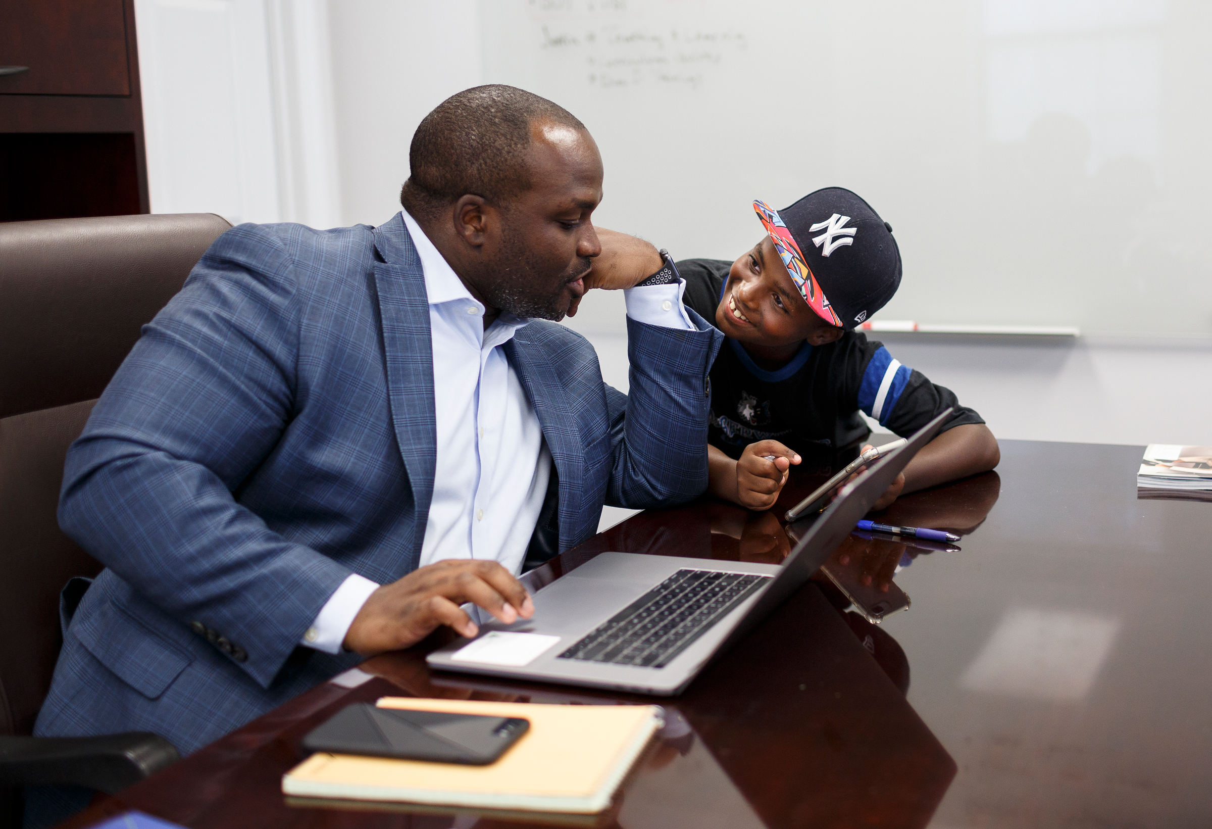 Hamilton County Schools Superintendent Bryan Johnson talks with his son Bryan while working in his office on Thursday, July 12, 2018, in Chattanooga, Tenn. Both of Johnson's children go to public schools in Hamilton County.