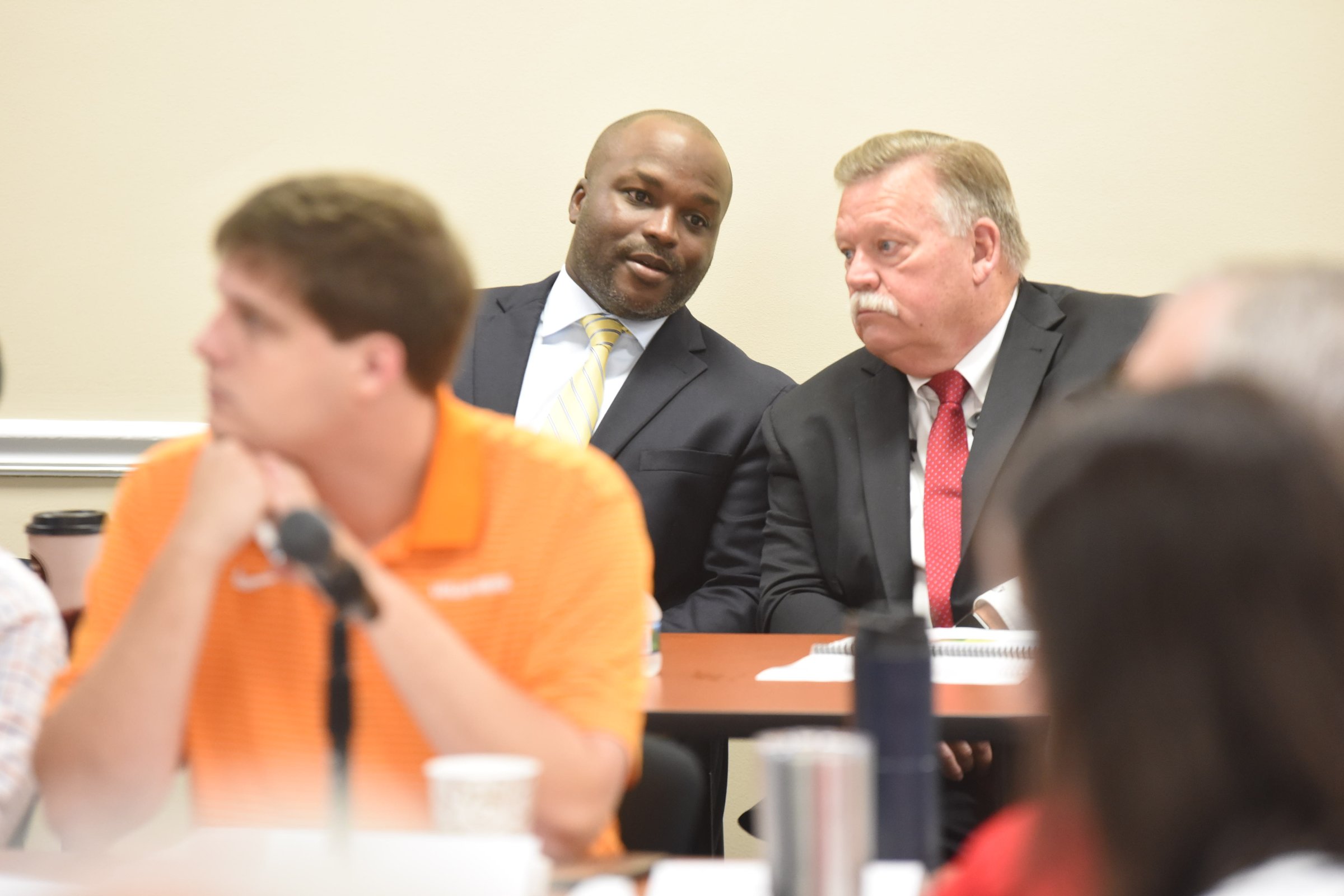 Hamilton County Mayor Jim Coppinger, right, leans to listen to Dr. Bryan Johnson Tiuesday at the Facilities Audit and Budget Discussion for school board members and county commissioners.