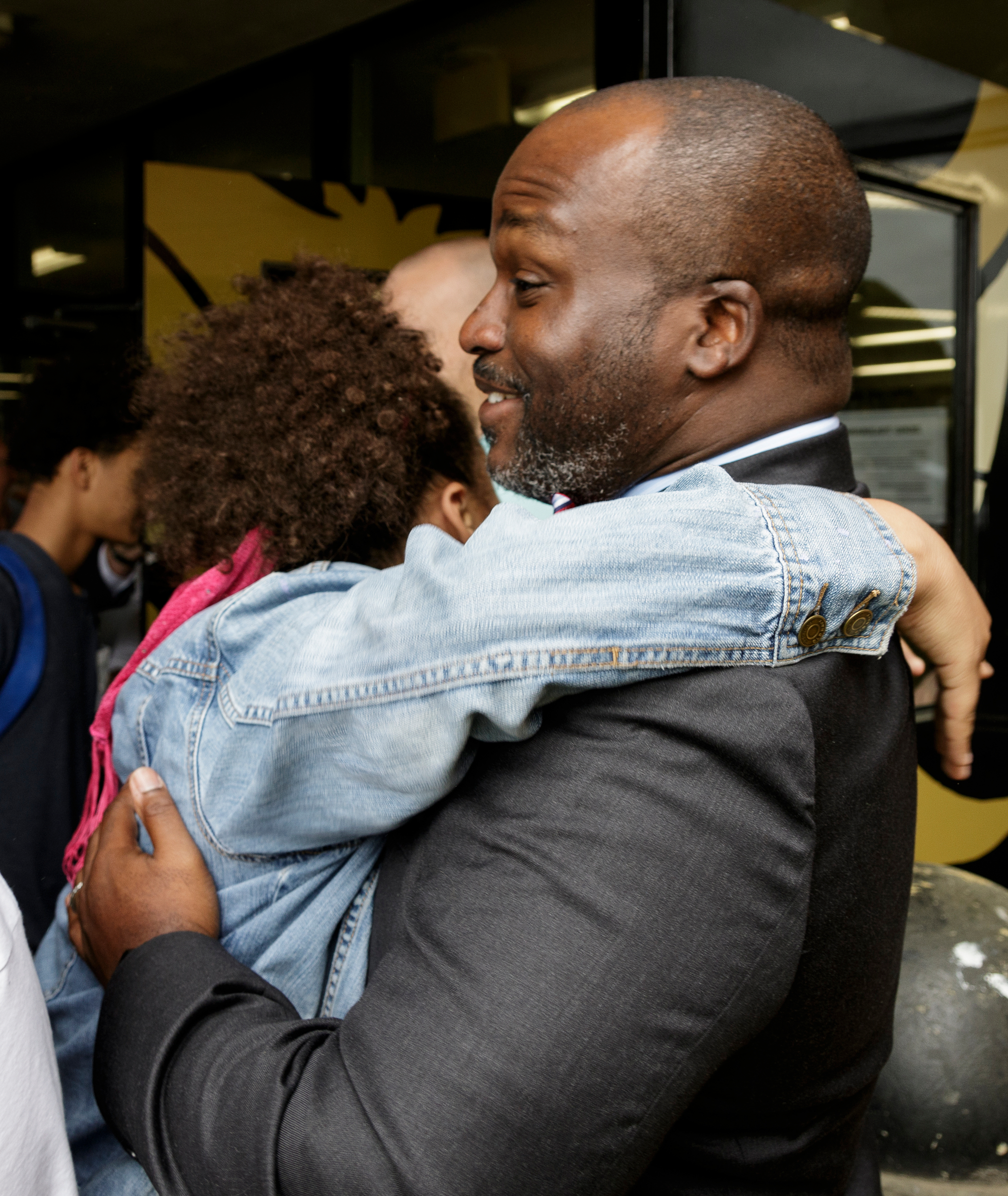 Hamilton County Schools superintendent Bryan Johnson gets a surprise hug from design team member Jade Sharp after the surprise arrival of the Vans bus at Hixson High School on Thursday, May 17, 2018, in Chattanooga, Tenn. Hixson was awarded $75,000 after their Vans shoe design competition team beat more than 500 other schools to win the contest.