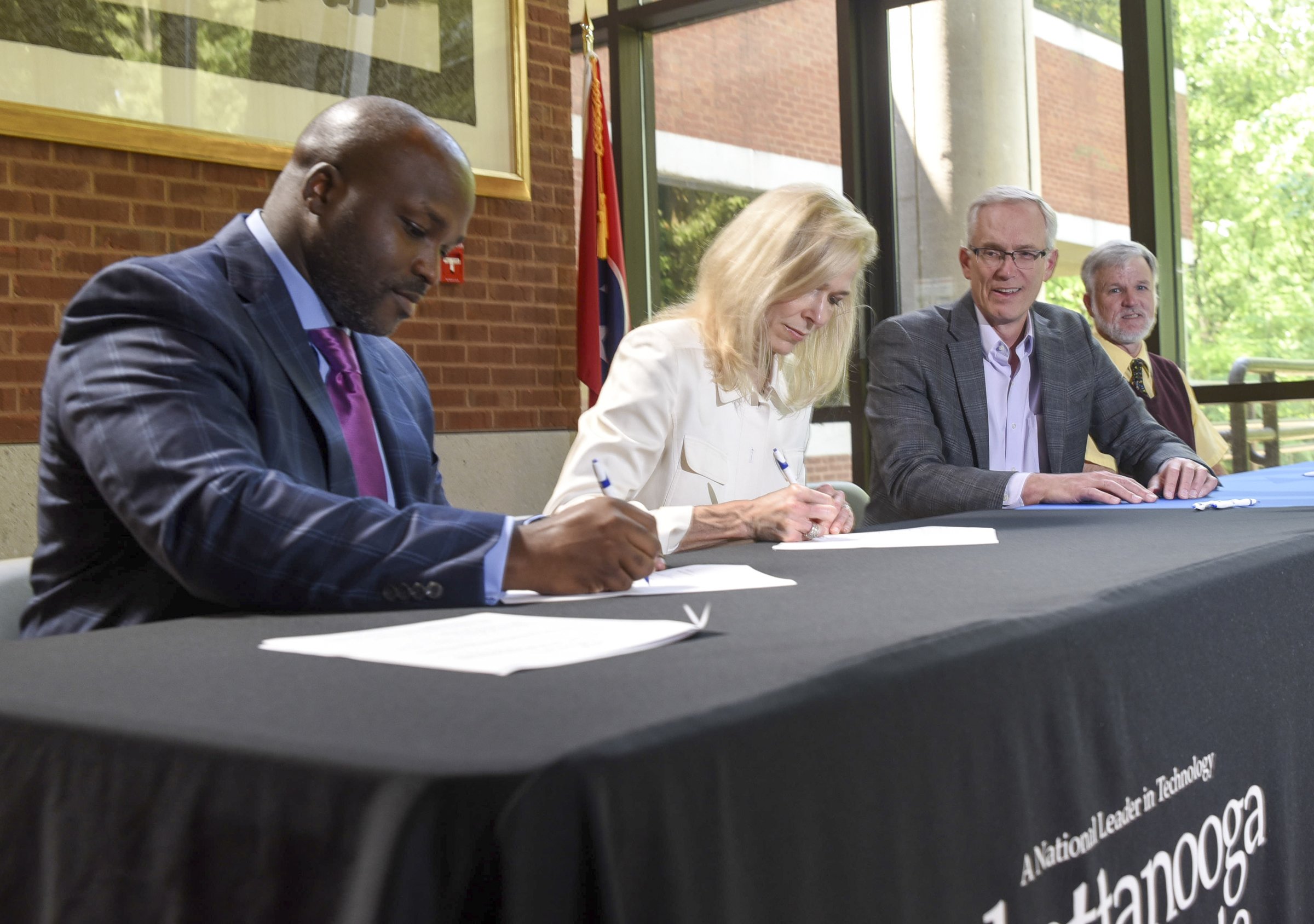 Dr. Bryan Johnson, left, Hamilton County School superintendent, and Dr. Rebecca Ashford, president of Chattanooga State Community College, sign a partnership agreement Friday to allow TCAT certified teachers to teach Carreer and Technical Education courses at four participating Hamilton County high schools that will allow students to earn both secondary and post secondary credits. Also signing were Dr. Jim Barrott, third from left, executive vice president Technical College at Chattanooga State and Dr. John Maynard, CTE director for Hamilton County Schools. The signing ceremony took place in the lobby of The Center for Business and Industry Health at Chattanooga State.