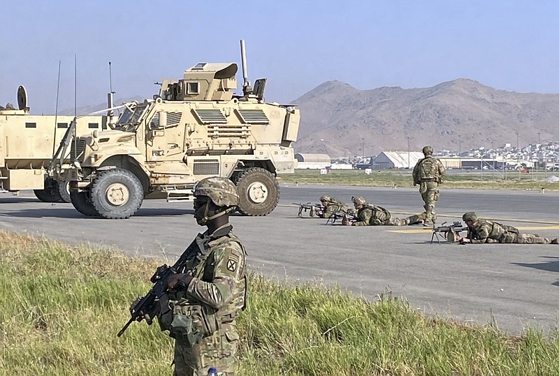 U.S soldiers stand guard along a perimeter at the international airport in Kabul, Afghanistan, Monday, Aug. 16, 2021. (AP Photo/Shekib Rahmani)


