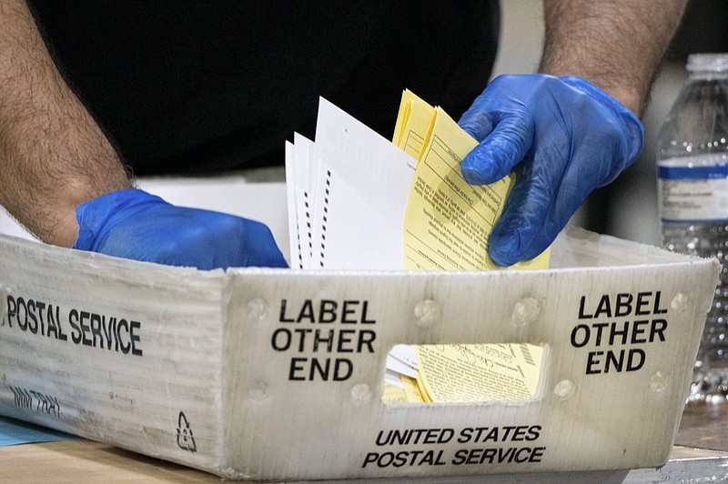 FILE - In this Jan. 5, 2021 file photo, Fulton County Georgia elections workers process absentee ballots for the Senate runoff election in Atlanta. (AP Photo/Ben Gray, File)


