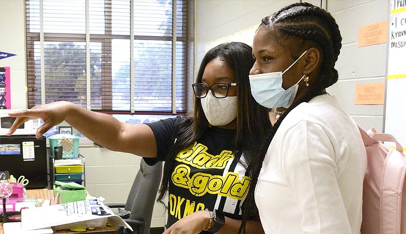 Staff Photo by Robin Rudd / Eighth Grade Math teacher Jasmine Everett directs a student. Orchard Knob Middle School started the 2021-2022 school year under a Hamilton County Schools system wide mask mandate on August 12, 2021, because of the surge in the Delta variant of the Coronavirus.