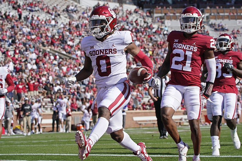 AP photo by Sue Ogrocki / Oklahoma running back Eric Gray (0) runs into the end zone to score a touchdown in front of defensive back Kendall Dennis during the Sooners' spring game on April 24 in Norman, Okla. Gray, defensive back Key Lawrence and offensive tackle Wanya Morris are all former Tennessee players who transferred in the offseason to join the Sooners.