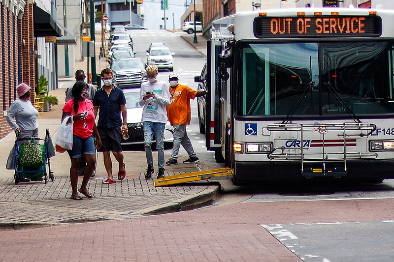 Staff photo by Troy Stolt / Riders exit a Carta bus on Market Street on Monday, Aug. 16, 2021 in Chattanooga, Tenn. The City of Chattanooga has announced it will be reinstating fares for CARTA buses for the first time since the spring of 2020. 