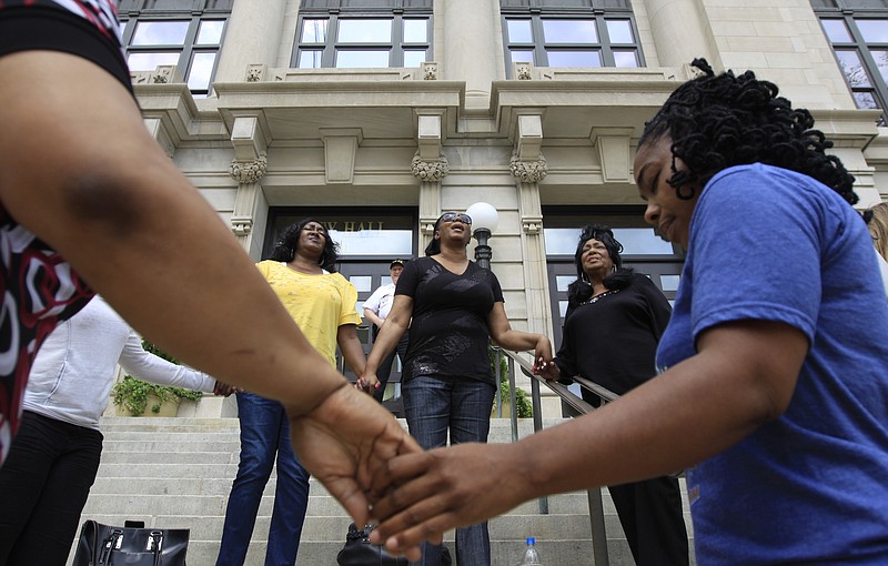 Staff File Photo / A group of women pray on the steps of Chattanooga City Hall during a 2011 Mothers Against All Violence rally.
