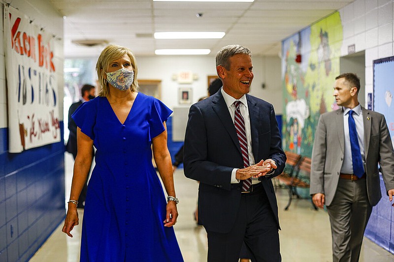 Staff photo by Troy Stolt / Principal Ruth Pohlman and Governor Bill Lee, unmasked, walk down the hall at McConnell Elementary School in Hixson on Wednesday when the school received the Governor's Civic Seal, an award for prioritizing teaching the nation's history.