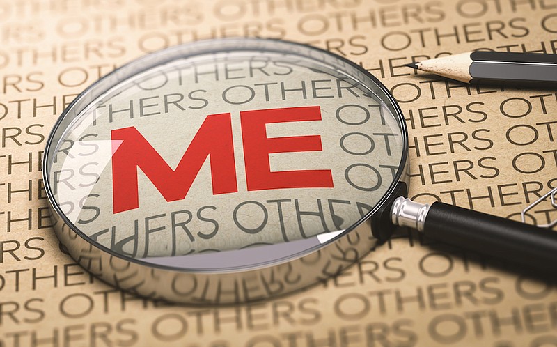 Magnifying glass over a paper background with focus on the word me (concept of egocentrism). / Photo credit: Getty Images/iStock/Olivier Le Moal