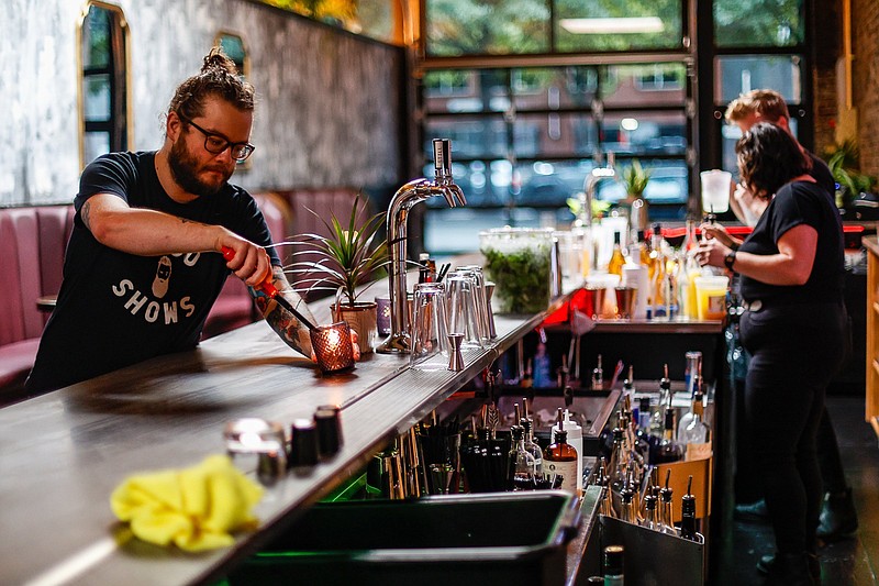 Staff photo by Troy Stolt / Matt McPeak, part owner of No Hard Feelings, located at 806 Broad Street, prepares for service on Tuesday, Aug. 17, 2021 in Chattanooga, Tenn.