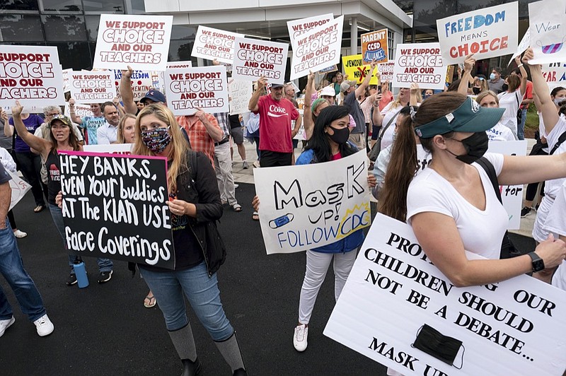 People in favor of and against a mask mandate for Cobb County schools gather and protest ahead of the school board meeting Thursday, Aug. 19, 2021, in Marietta, Ga. (Ben Gray/Atlanta Journal-Constitution via AP)


