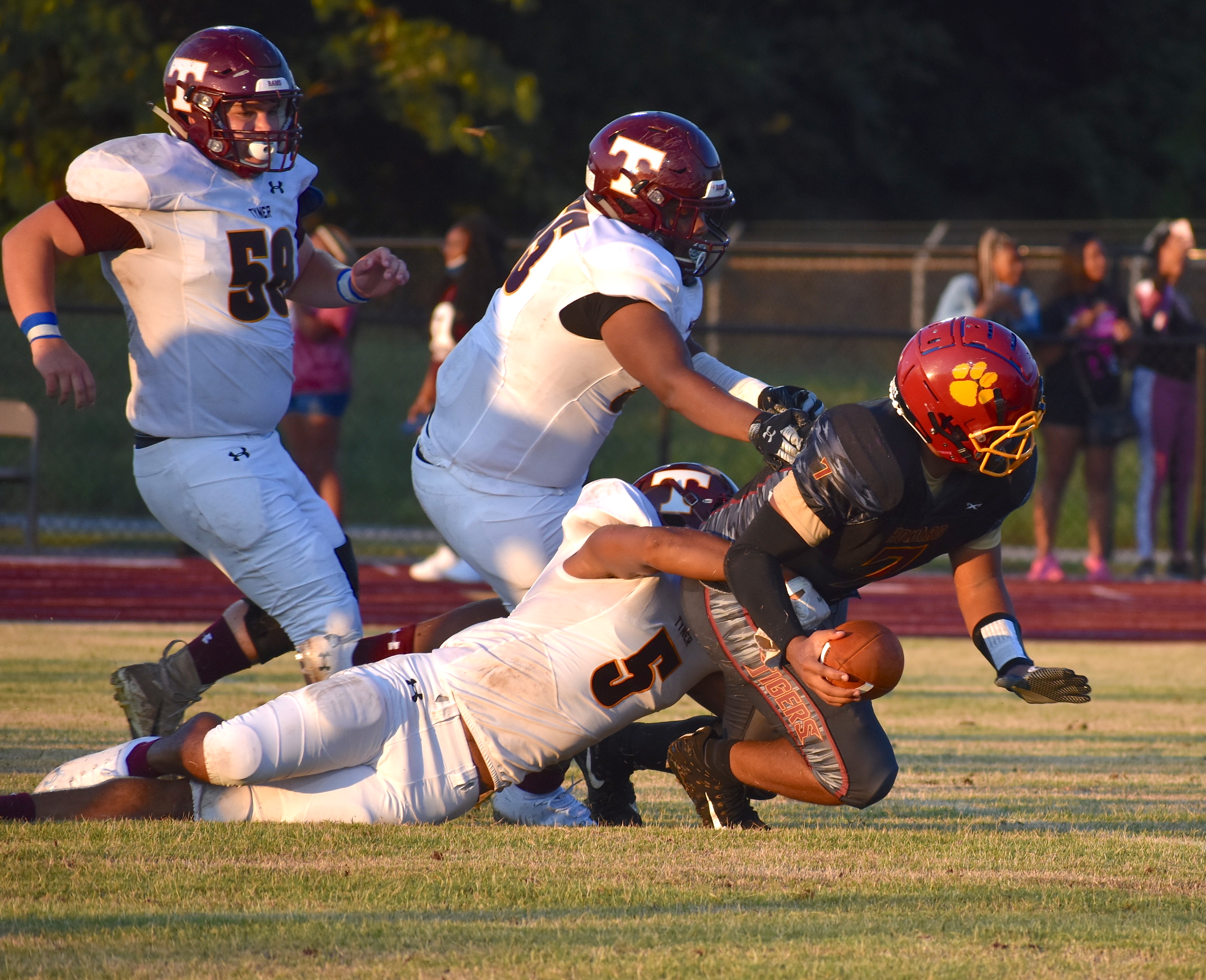 Staff photo by Patrick MacCoon / Tyner's Latavious Conyers (5) forces the ball loose on a sack during Friday night's season opening win at Howard.