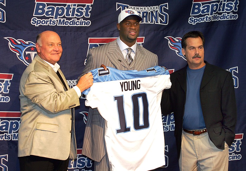AP photo by Neil Brake / Tennessee Titans general manager Floyd Reese, left, and head coach Jeff Fisher, right, stand alongside Vince Young after the team made the former University of Texas quarterback the third overall pick in the 2006 NFL draft.
