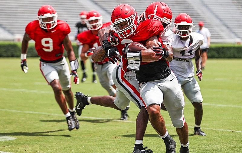 Georgia photo by Mackenzie Miles / Sophomore running back Kendall Milton fights for yardage Saturday afternoon during Georgia's second preseason scrimmage.