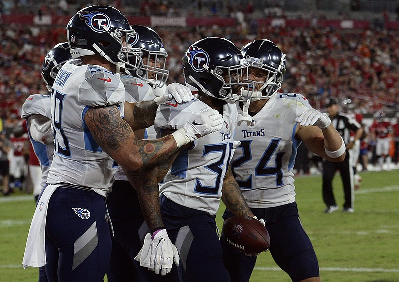 AP photo by Jason Behnken / Tennessee Titans cornerback Briean Boddy-Calhoun, second from right, celebrates after returning a fumble 42 yards for a touchdown during Saturday night's preseason game against the host Tampa Bay Buccaneers.