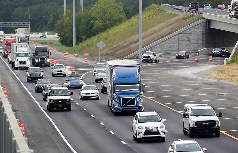 Staff Photo by Robin Rudd / Traffic moves through the junction of Interstate 24 West, at left, and Interstate 75 North on Friday. The striped area, at right, is the new surface that ends just west of the Spring Creek Road overpass. All lanes are complete as the $133.5 million Split project reaches the finish line. The problem is, until phase 2 of the Split project is begun and finished, the backup on I-75 North's on-ramp for I-24 West will linger as the two-into-one lanes merge.