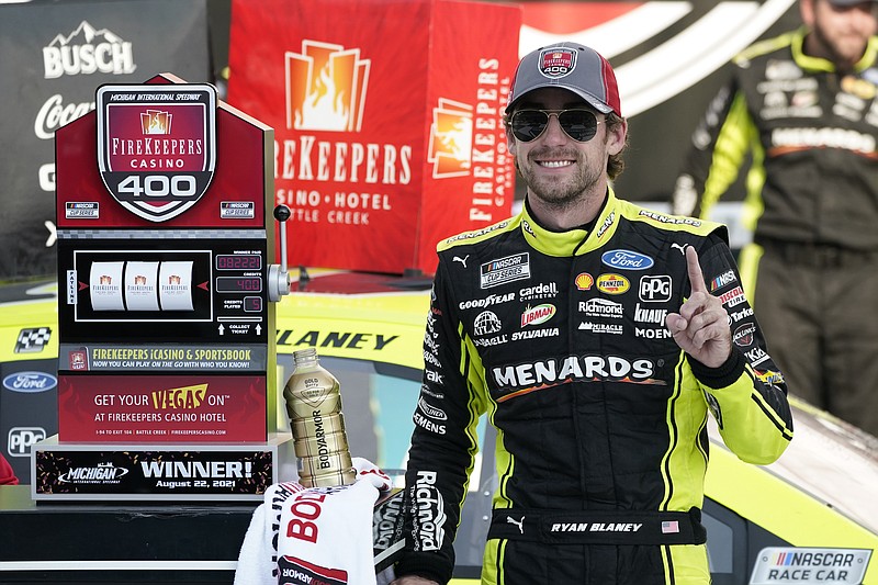 AP photo by Carlos Osorio / Ryan Blaney celebrates after winning Sunday's NASCAR Cup Series race at Michigan International Speedway.