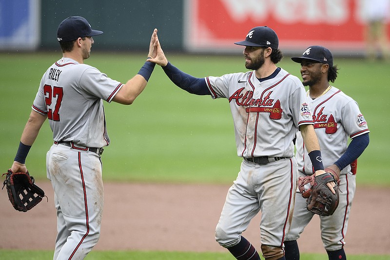 Atlanta Braves' Austin Riley (27), Dansby Swanson, center, and Ozzie Albies, right, celebrate after a baseball game against the Baltimore Orioles, Sunday, Aug. 22, 2021, in Baltimore. The Braves won 3-1. (AP Photo/Nick Wass)