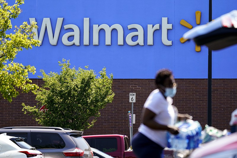 A shopper loads items into her car in the parking lot of a Walmart in Willow Grove, Pa., Wednesday, May 19, 2021. Walmart says it will start commercializing its delivery service, using contract workers, autonomous vehicles and even drones to deliver other retailers' products directly to their customers' homes as fast as just a few hours. (AP Photo/Matt Rourke)