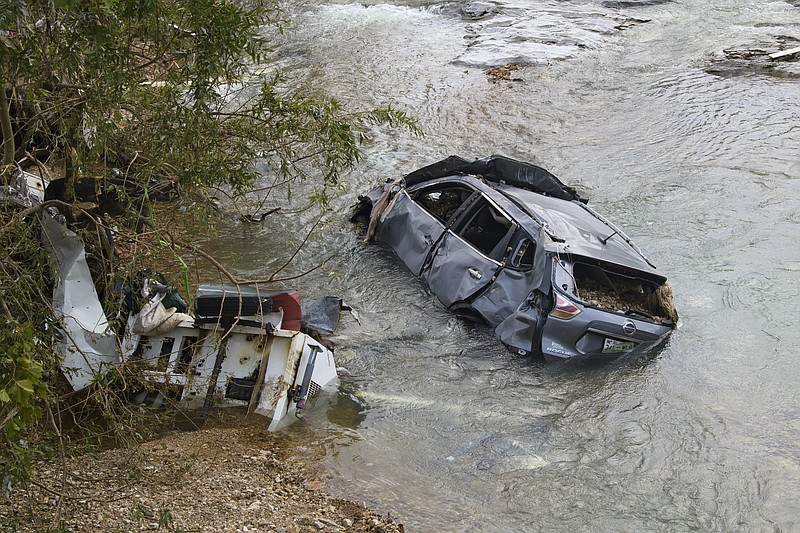 AP Photo by John Amis / A car and other structure were one of many swept up in a flash flood recently in Waverly, Tennessee.