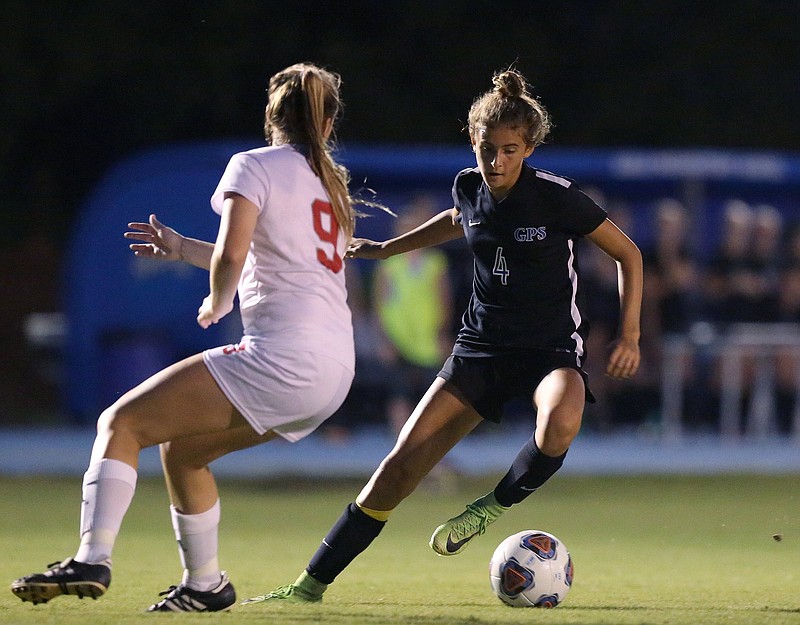 Staff photo / GPS soccer standout Kennedy Ball, right, dribbles around Baylor's Ara Rhodes during a home game in October 2018.