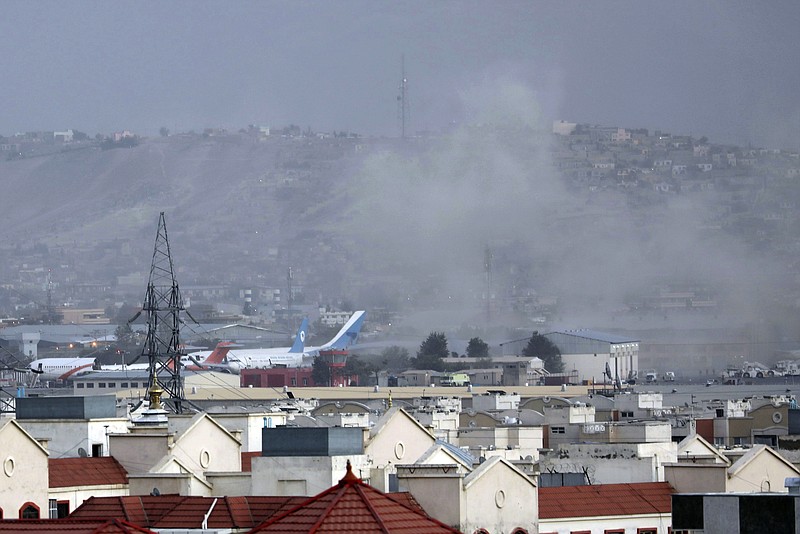 AP Photo/Wali Sabawoon / Smoke rises from a deadly explosion outside the airport in Kabul, Afghanistan, on Thursday, Aug. 26, 2021. Two suicide bombers and gunmen have targeted crowds massing near the Kabul airport, in the waning days of a massive airlift that has drawn thousands of people seeking to flee the Taliban takeover of Afghanistan.