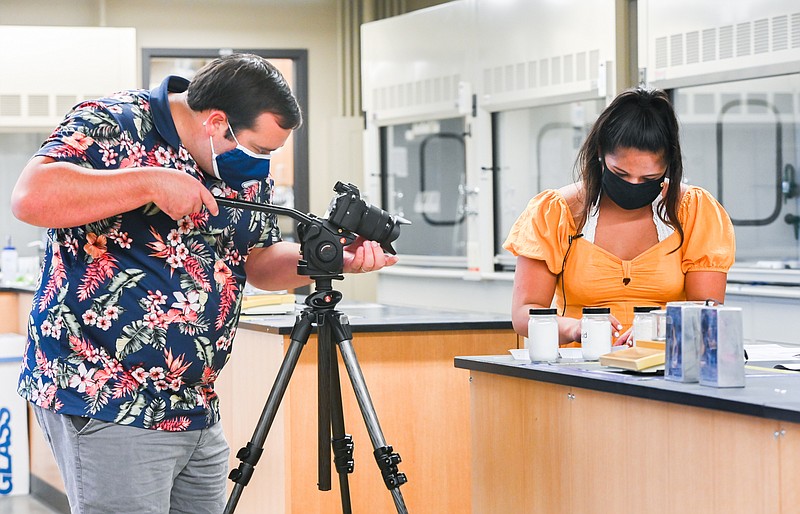 Photo courtesy of Angela Foster/University of Tennessee at Chattanooga / UTC's Jacob Cagle videos student Mackenzie Wall as she conducts lab work in organic chemistry. The video was posted online, so students could complete their course requirements when all classes at UTC were online during the pandemic.