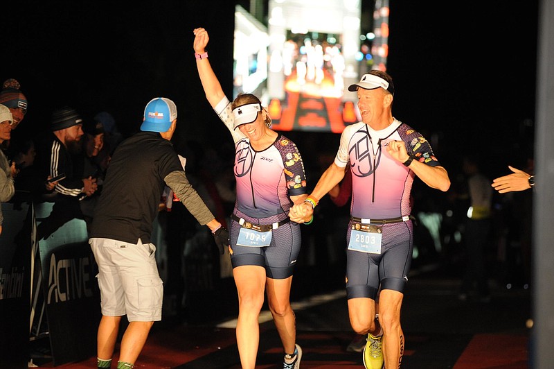 Photo contributed by FinisherPix / April and David Pearson cross the finish line together at the 2019 Florida Ironman, marking April's first Ironman finish and David's 12th. Through all the miles he's covered, David calls this his proudest Ironman moment.
