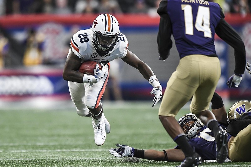 Auburn photo by Todd Van Emst / Auburn running back Boobie Whitlow fights for yardage during the 2018 Chick-fil-A Kickoff Game in Atlanta, where the No. 9 Tigers prevailed 21-16 over No. 6 Washington. College football kickoff games are becoming tougher to schedule as more top teams compile home-and-home series.