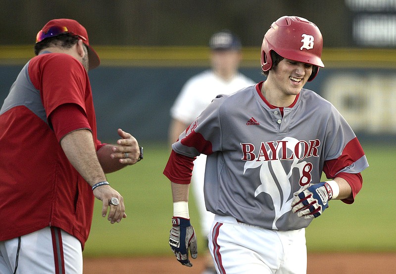 Staff photo by Robin Rudd / Baylor's Cooper Kinney, right, is congratulated by co-coach Greg Elie as he rounds third base after hitting a home run during a game at Chattanooga Christian in March 2019. Kinney, who as a senior this past spring helped the Red Raiders to a third straight state title, is now in the Tampa Bay Rays' minor league system.