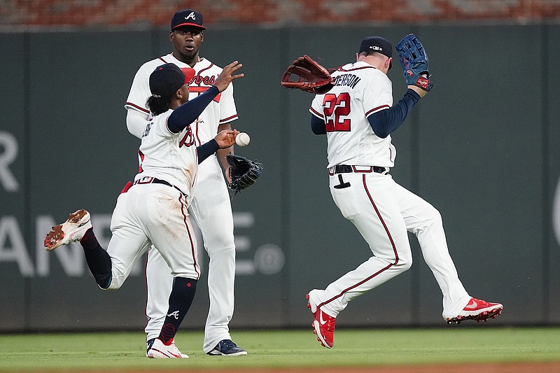 AP photo by John Bazemore / Atlanta Braves second baseman Ozzie Albies, front left, right fielder Jorge Soler and center fielder Joc Pederson, right, can't catch a fly ball hit by the San Francisco Giants' Brandon Crawford during the sixth inning of Saturday's game in Atlanta.