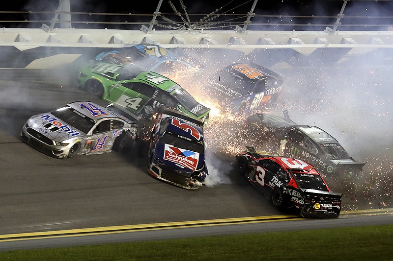 AP photo by John Chilton / Chase Briscoe (14), Kyle Larson (5), Kevin Harvick (4), Austin Dillon (3), Daniel Suarez (99) and Corey LaJoie (7) crash in the third turn at Daytona International Speedway on the final lap of a NASCAR Cup Series race Saturday night in Daytona Beach, Fla.