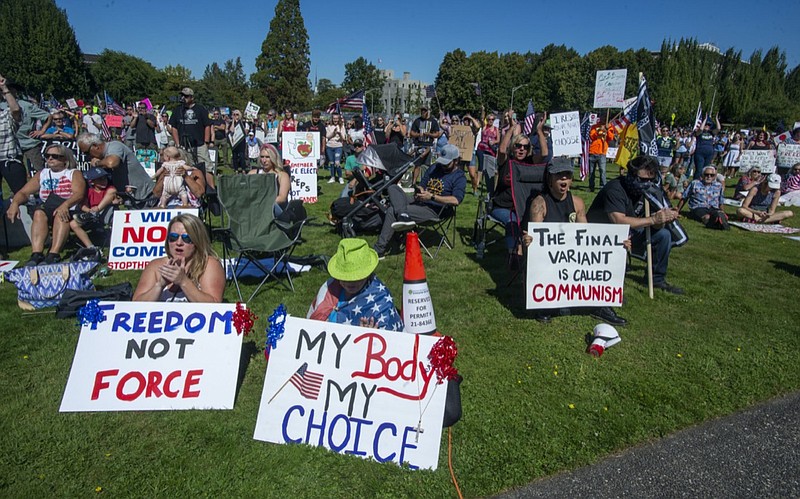 People gather outside the Capitol to protest Gov. Jay Inslee's vaccine mandate for state workers, Saturday, Aug. 28, 2021 in Olympia, Wash. (Drew Perine/The News Tribune via AP)

