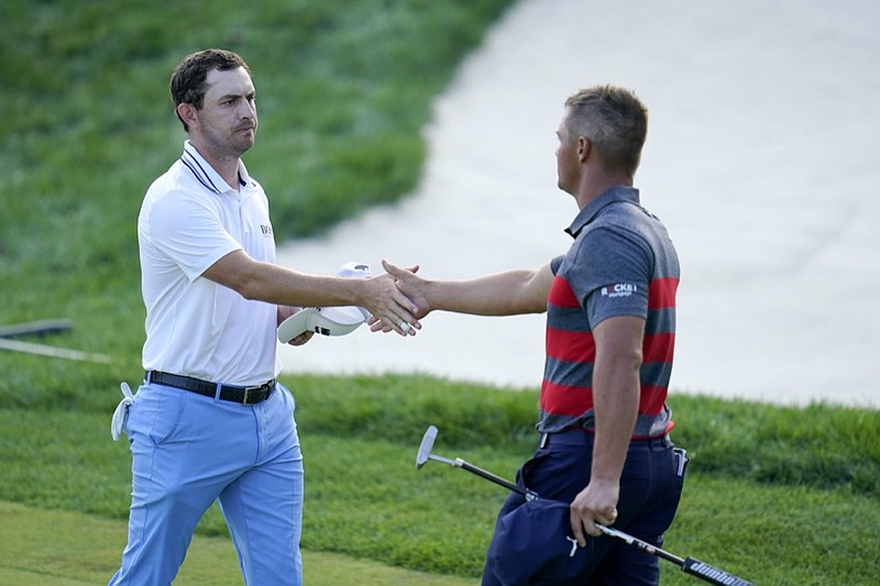 Patrick Cantlay, left, and Bryson DeChambeau shake hands after they completed the 18th hole tied to go into playoff play during the final round of the BMW Championship golf tournament, Sunday, Aug. 29, 2021, at Caves Valley Golf Club in Owings Mills, Md. (AP Photo/Julio Cortez)


