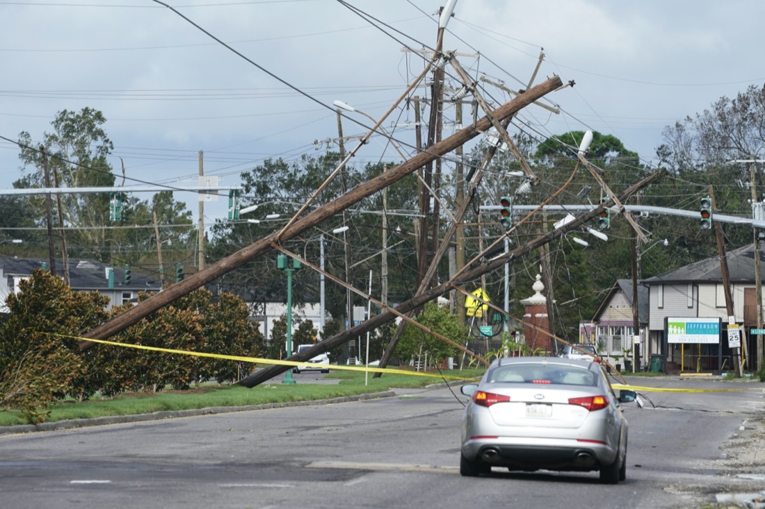 Traffic diverts around downed power lines Monday, Aug. 30, 2021, in Metairie, La. A fearsome Hurricane Ida has left scores of coastal Louisiana residents trapped by floodwaters and pleading to be rescued, while making a shambles of the electrical grid across a wide swath of the state in the sweltering, late-summer heat. One of the most powerful hurricanes ever to hit the U.S. mainland has now weakened into a tropical storm as it pushes inland over Mississippi with torrential rain and shrieking winds. (AP Photo/Steve Helber)
