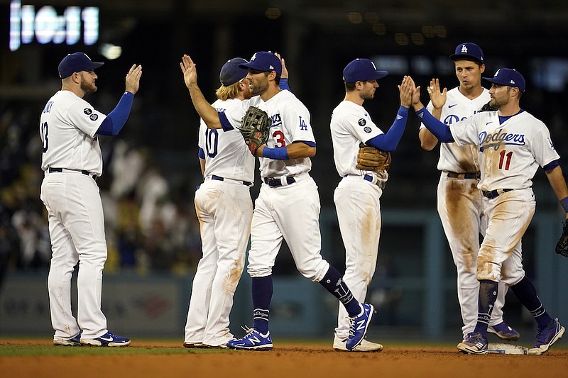 The Los Angeles Dodgers celebrate a win over the Atlanta Braves during a baseball game Monday, Aug. 30, 2021, in Los Angeles. (AP Photo/Marcio Jose Sanchez)